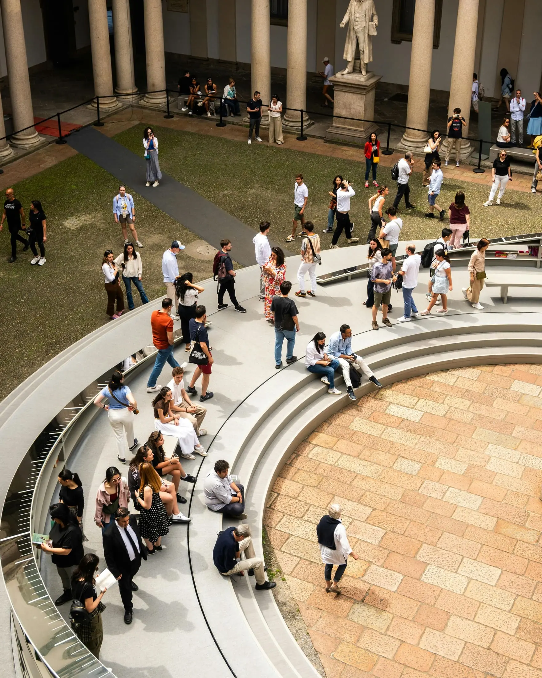 People gathered in a busy campus courtyard
