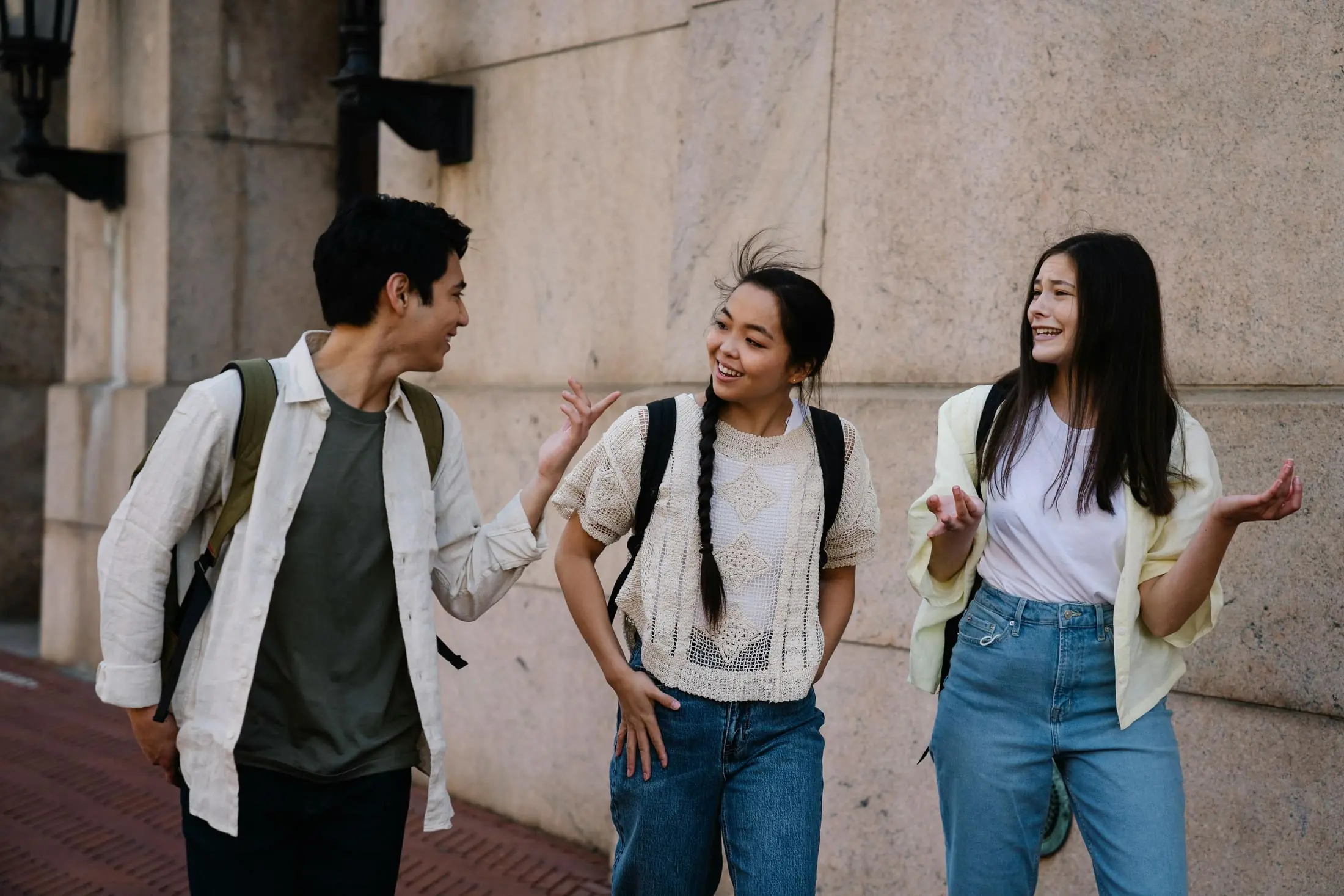 Friends talking while walking on campus