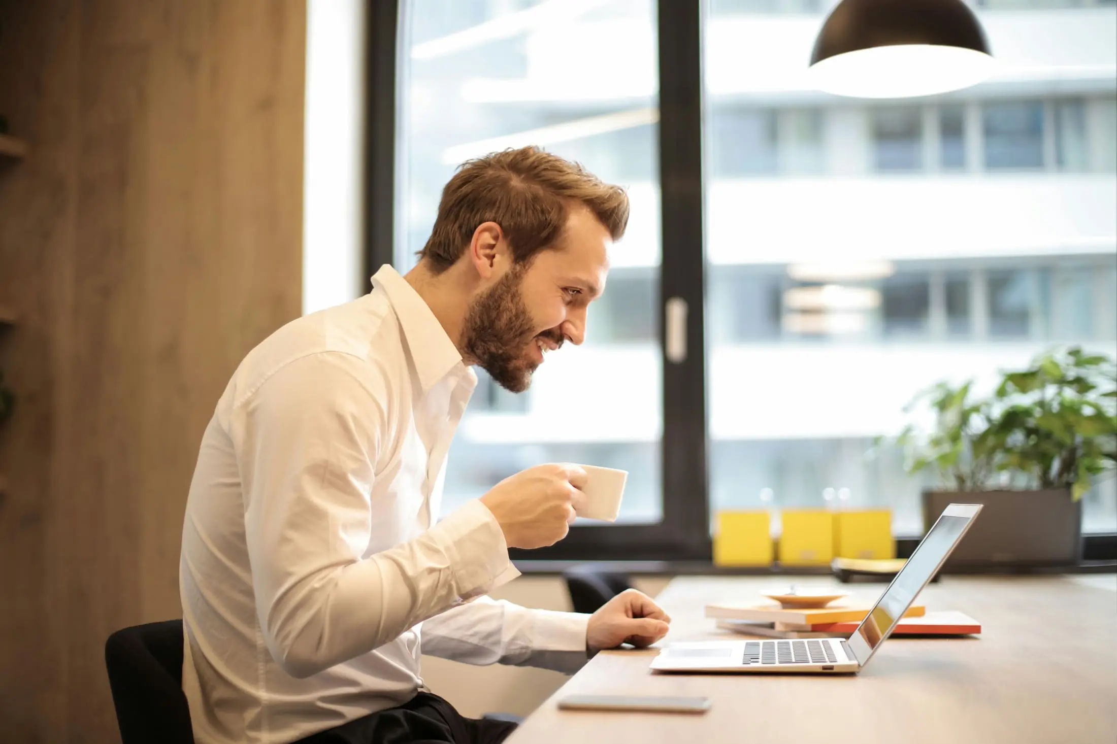 Person using a laptop with coffee