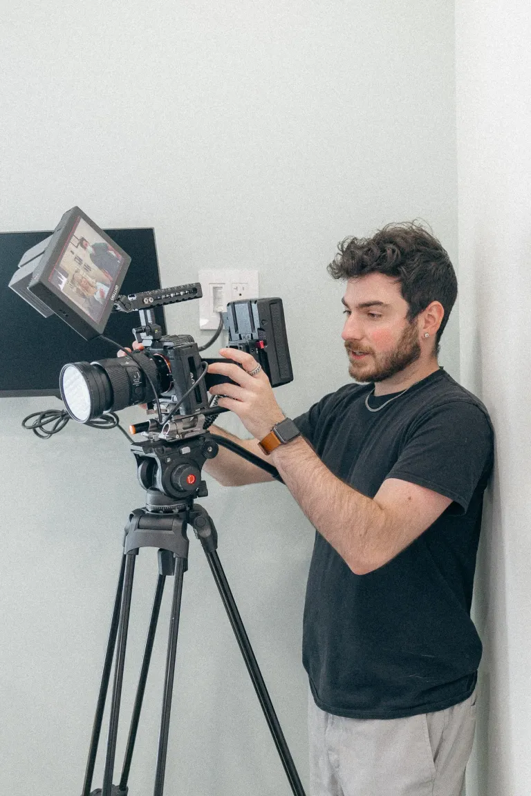 Isaac Aiello adjusting a professional camera