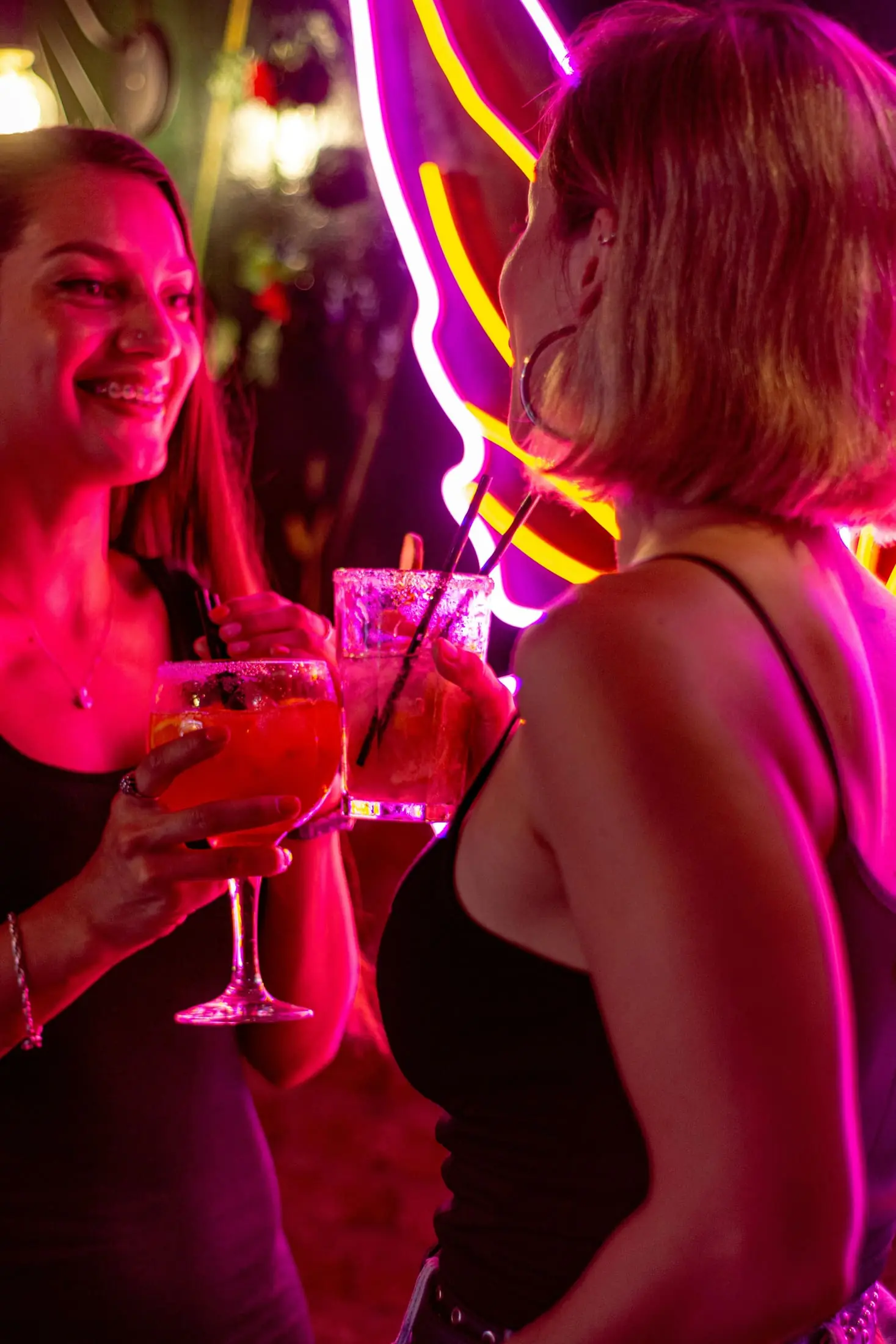 Two people talking in a bright nightlife setting