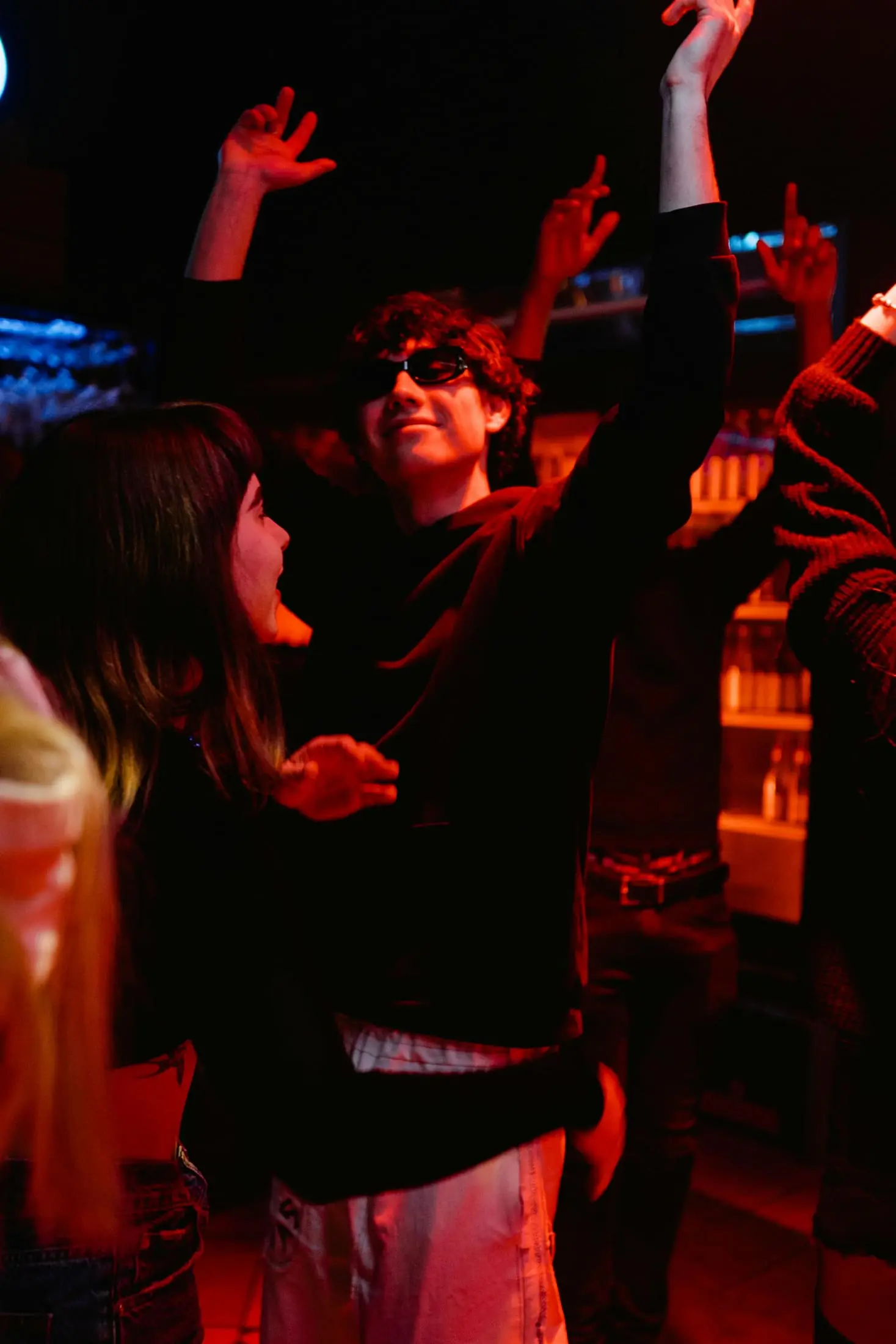 People dancing in a dark social setting
