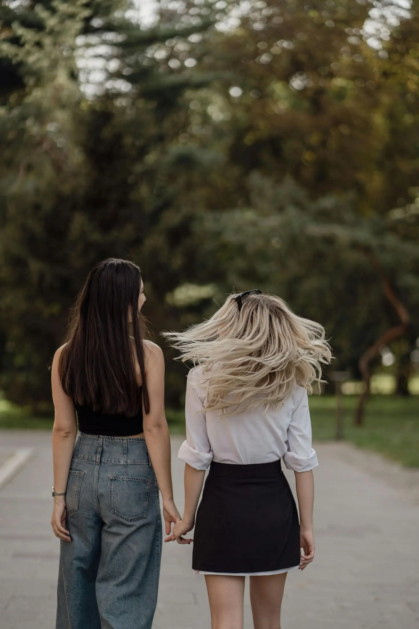 Two friends walking together in a park