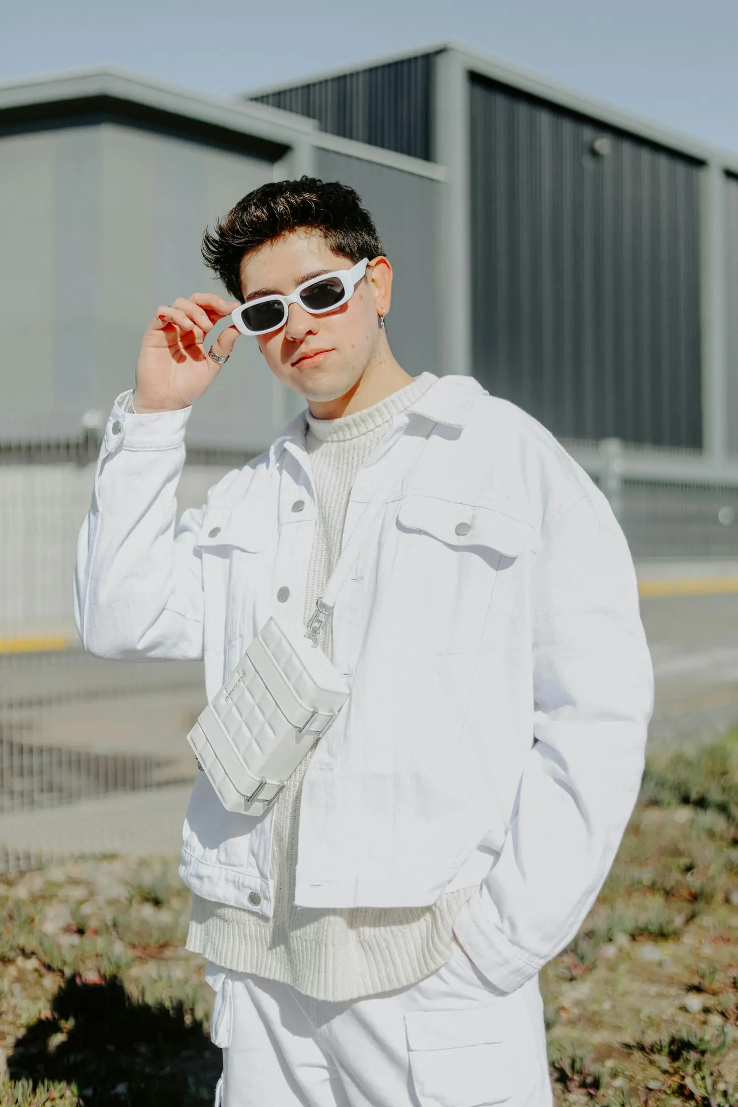 Person in white sunglasses outside